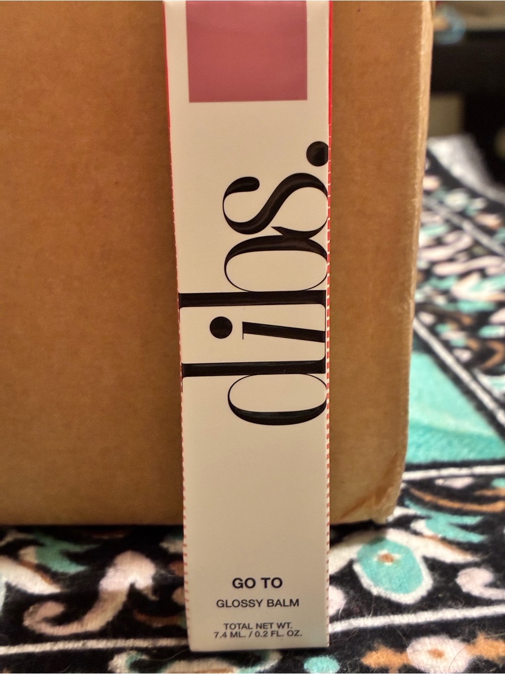 Dibs Go To Glossy Balm in shade rock candy